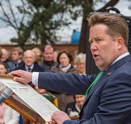 Minister Darragh O'Brien reading the proclamation outside St. Sylvester's Church in Malahide, commemorating the 1916 Easter Rising. Photo by Dougie Farrelly, Professional Photographer | Silverscreen Film & Photography.