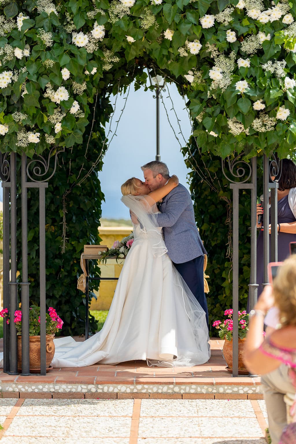 Newlyweds share a kiss gazebo at the private and exclusive Cortijo Maria Luisa in Nerja, Spain. Photo by Dougie Farrelly, renowned Irish Professional Wedding Photographer. Collaboration with Silverscreen Film & Photography