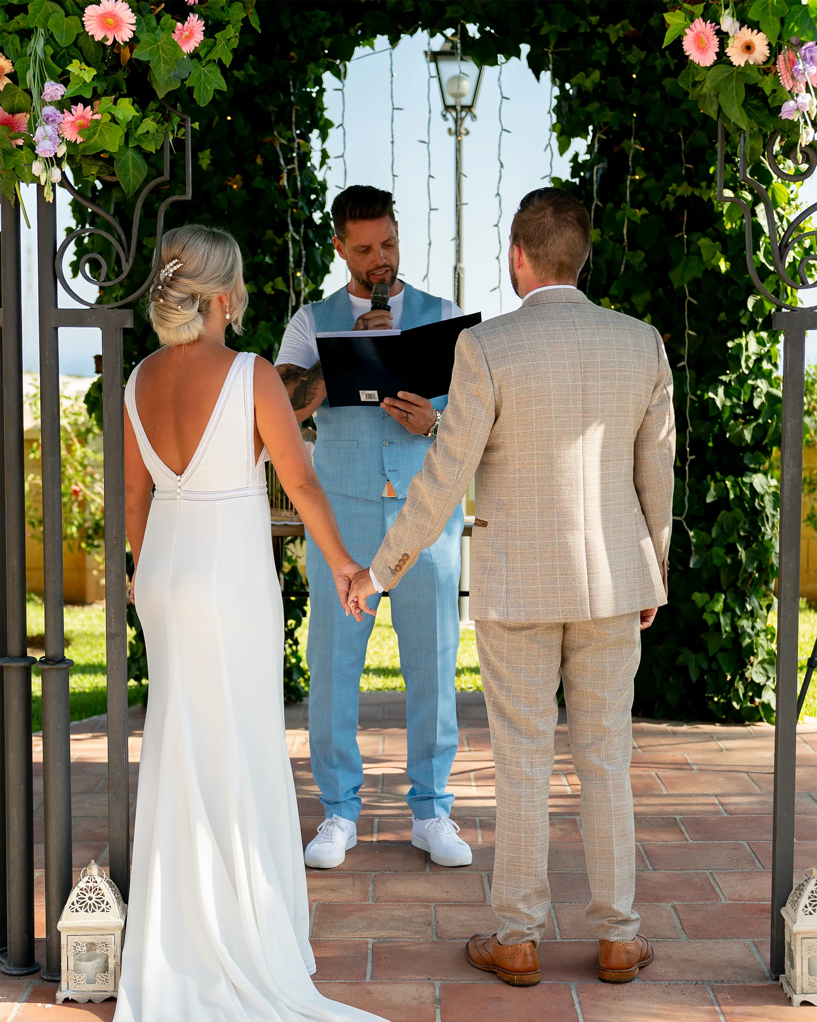 294_RG02 – Rachel Smyth and George McMahon Wedding Ceremony, Nerja, Spain Rachel Smyth and George McMahon holding hands during their wedding ceremony at Cortijo Maria Luisa in Nerja, Spain, with Keith Duffy as celebrant.