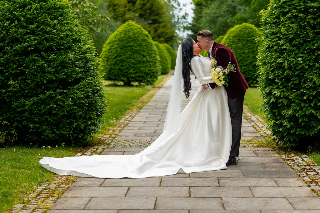 Romantic Kiss at Exclusive Wedding Venue in Ireland — Silverscreen.ie (© All Rights Reserved Dougie Farrelly Silverscreen.ie) Bride and groom share a kiss on a manicured garden walkway at an exclusive wedding venue in Ireland — elegant wedding photography by Dougie Farrelly, Silverscreen.ie. (© All Rights Reserved Dougie Farrelly Silverscreen.ie)