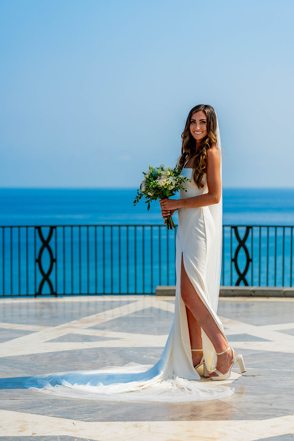 Irish bride standing with wedding bouquet at Balcón de Europa Nerja Spain with sea view on Costa del Sol