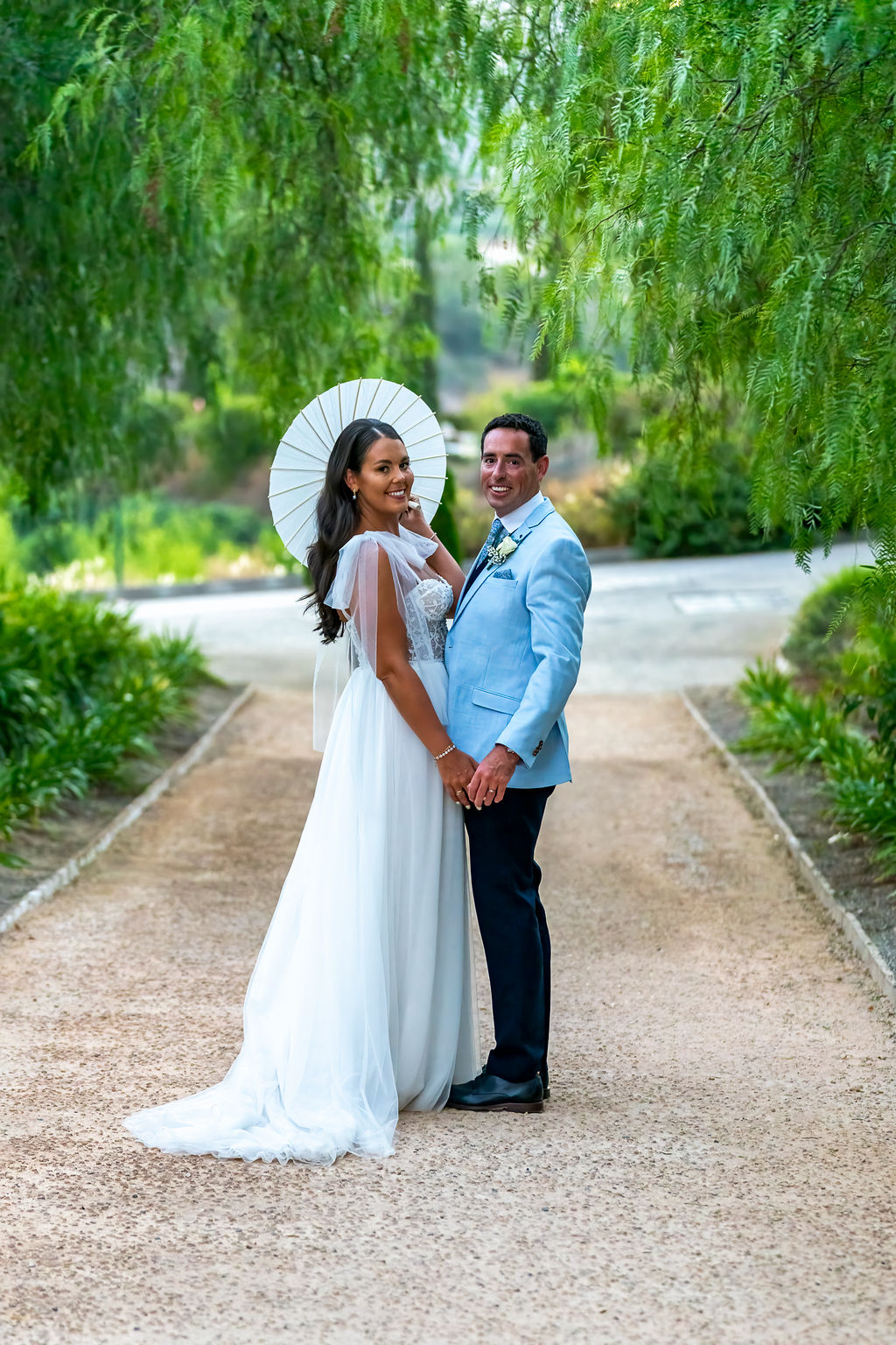 Irish bride and groom standing together on tree lined path during wedding in Costa del Sol Spain