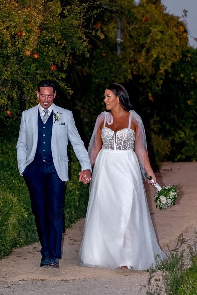 Irish Wedding in Spain – Couple Walking at Costa del Sol Venue | Silverscreen Film & Photography Irish bride and groom walking together at Costa del Sol wedding in Spain holding hands along garden path