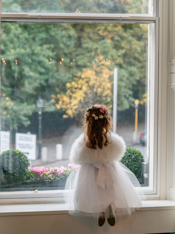 Flower girl looking out a window at The Shelbourne Hotel in Dublin. © All Rights Reserved Dougie Farrelly Silverscreen.ie
