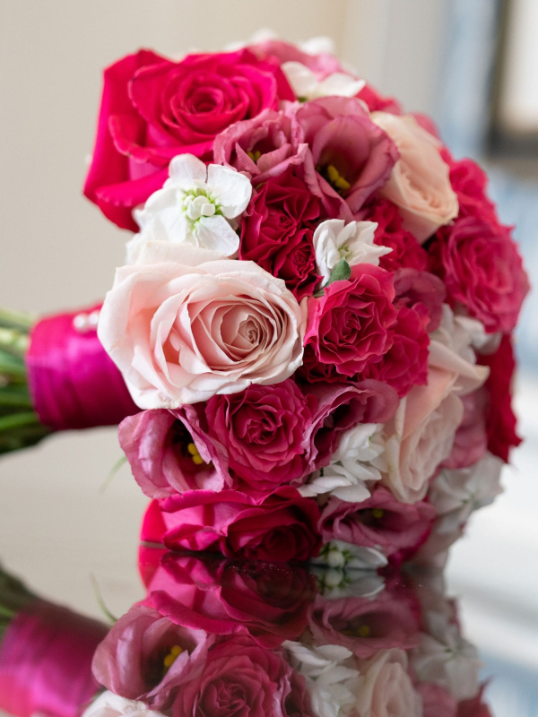 Pink and blush bridal bouquet reflected on a glass table at The Shelbourne Hotel wedding in Dublin.