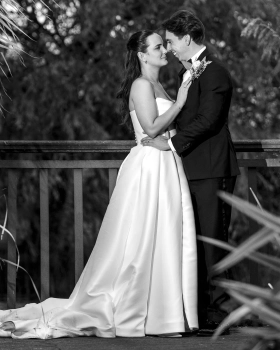 Black-and-white portrait of a bride and groom sharing a quiet moment at Ballymagarvey Village