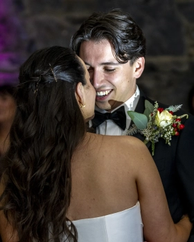 Newlywed couple sharing a joyful moment during their Ballymagarvey Village wedding reception