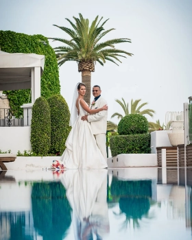 Newlyweds photographed poolside at Hotel Fuerte Marbella during their wedding in Marbella, Spain