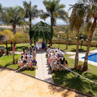 The bride and groom share a special moment by the pool during their wedding at Cortijo Maria Luisa in Nerja, Spain, surrounded by family and friends. Photo by Dougie Farrelly, Silverscreen.ie. Bride and groom’s wedding ceremony by the pool at Cortijo Maria Luisa, Nerja, Spain, surrounded by family and friends. Photo by Dougie Farrelly of Silverscreen.ie