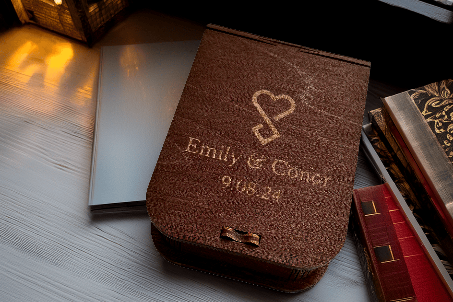 Wooden walnut USB box with engraved names and wedding date, photographed by Dougie Farrelly - Silverscreen.ie, with a wedding album and books in the background.